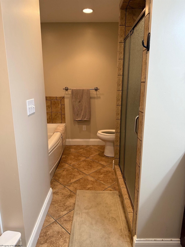 bathroom with a shower stall, baseboards, toilet, and a bath
