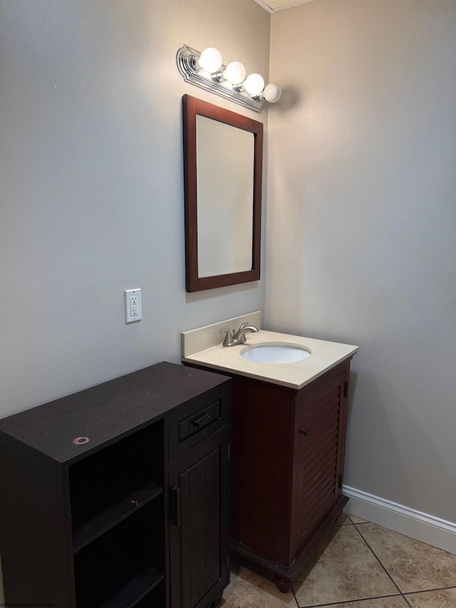bathroom with baseboards, tile patterned floors, and vanity