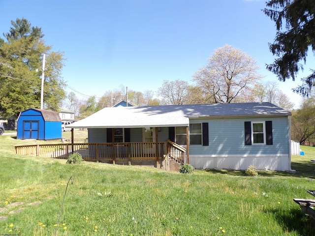 exterior space featuring a storage unit, a front yard, an outdoor structure, and a porch