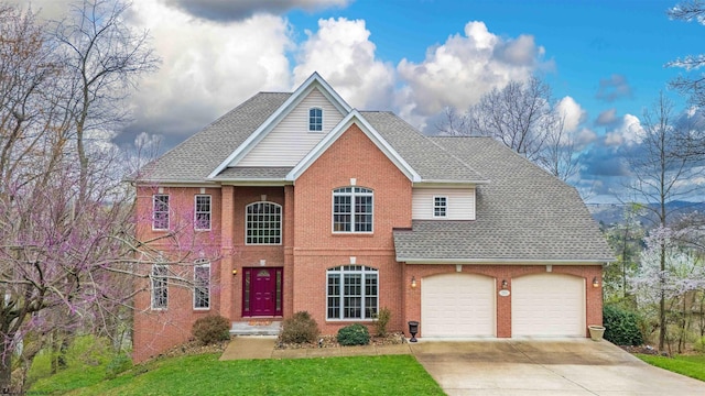 view of front of house with driveway, brick siding, a front yard, and roof with shingles