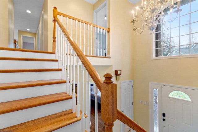entrance foyer with stairs, recessed lighting, and a notable chandelier