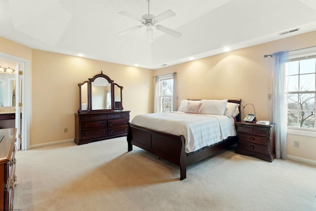 bedroom featuring baseboards, visible vents, and light carpet