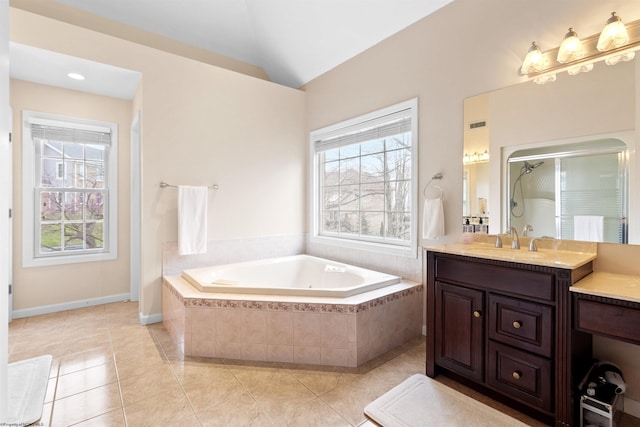 full bath featuring vaulted ceiling, vanity, a stall shower, a garden tub, and tile patterned flooring