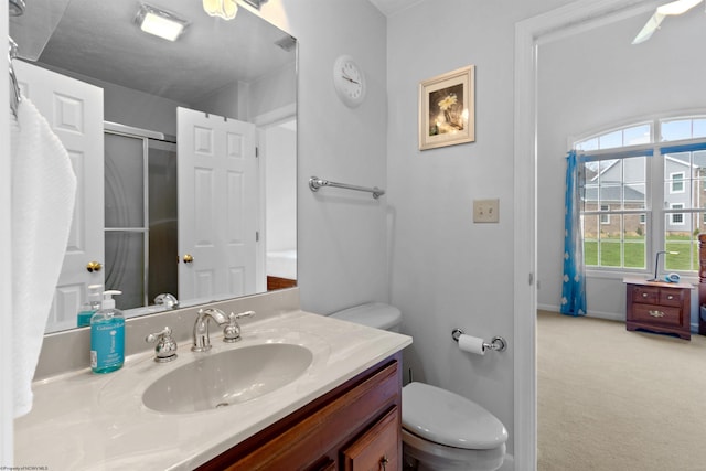 full bath with an enclosed shower, baseboards, toilet, and vanity