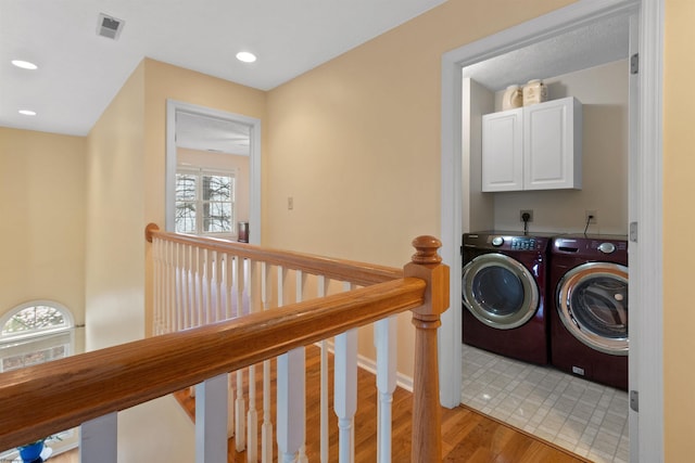 washroom with washing machine and clothes dryer, laundry area, visible vents, light wood-style floors, and recessed lighting