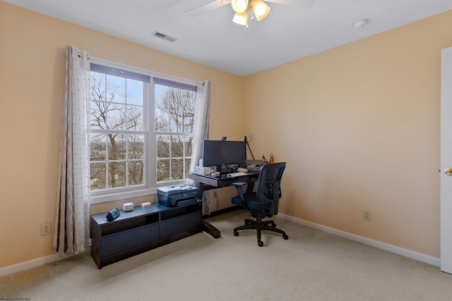 office space with baseboards, ceiling fan, visible vents, and carpet