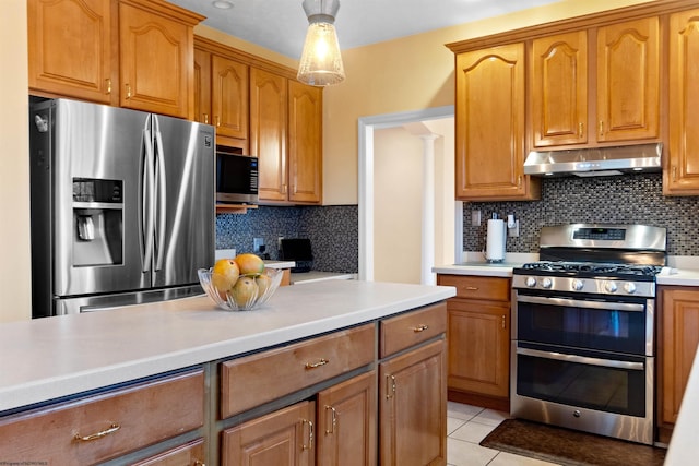 kitchen with light countertops, stainless steel appliances, under cabinet range hood, backsplash, and light tile patterned flooring