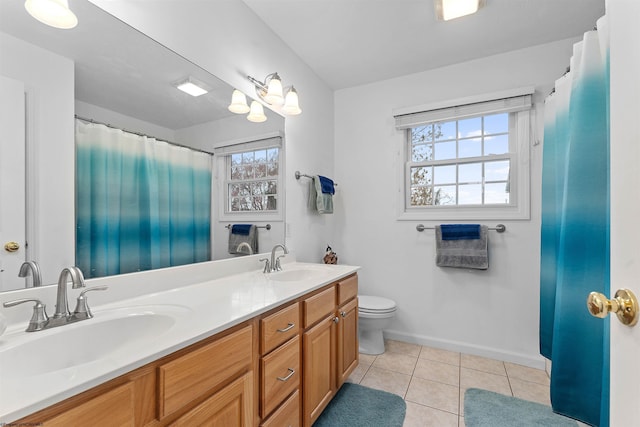 full bathroom featuring double vanity, a sink, toilet, and tile patterned flooring