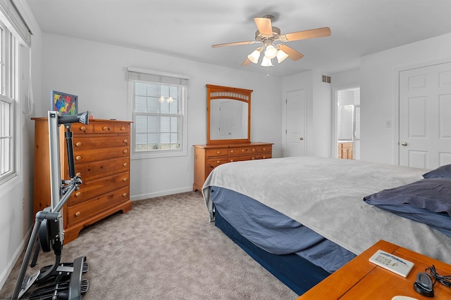 bedroom featuring baseboards, carpet floors, connected bathroom, visible vents, and ceiling fan