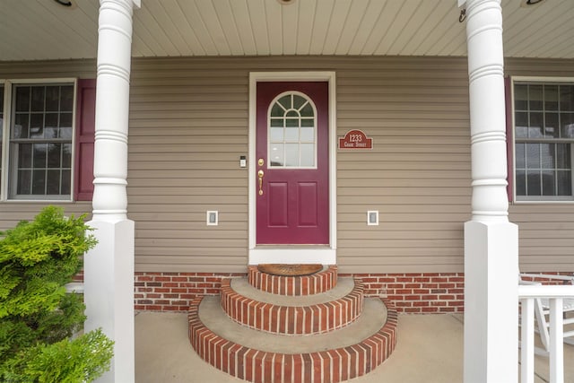 doorway to property featuring a porch