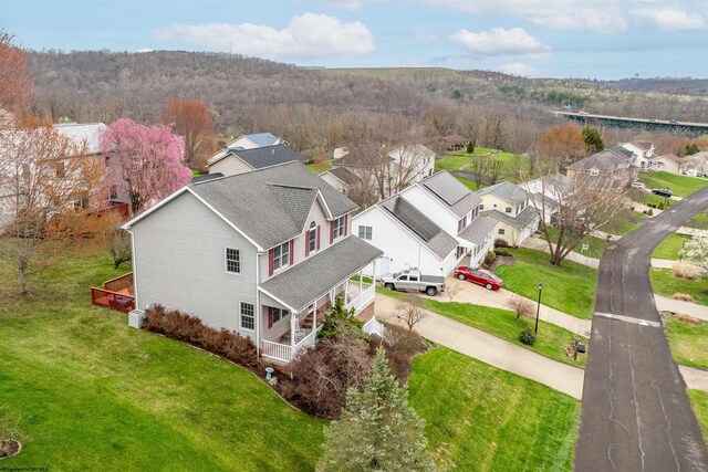 birds eye view of property with a residential view and a wooded view