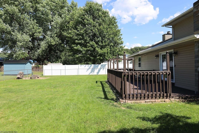 view of yard featuring fence and a wooden deck