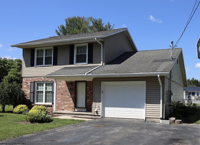 traditional home with aphalt driveway, brick siding, a garage, and roof with shingles