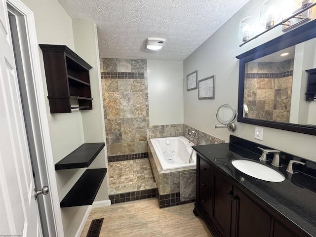 2458 Brushy Fork Rd, Buckhannon, WV 26201 - full bath featuring a tile shower, a textured ceiling, vanity, visible vents, and a whirlpool tub