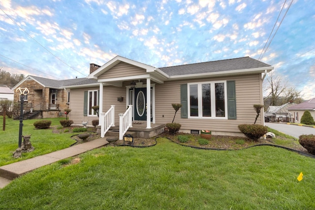 ranch-style home featuring a chimney and a front lawn