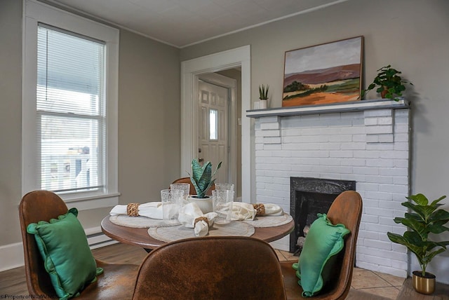dining space featuring a fireplace, plenty of natural light, and baseboard heating