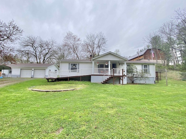 view of front of property with a garage, an outbuilding, and a front lawn