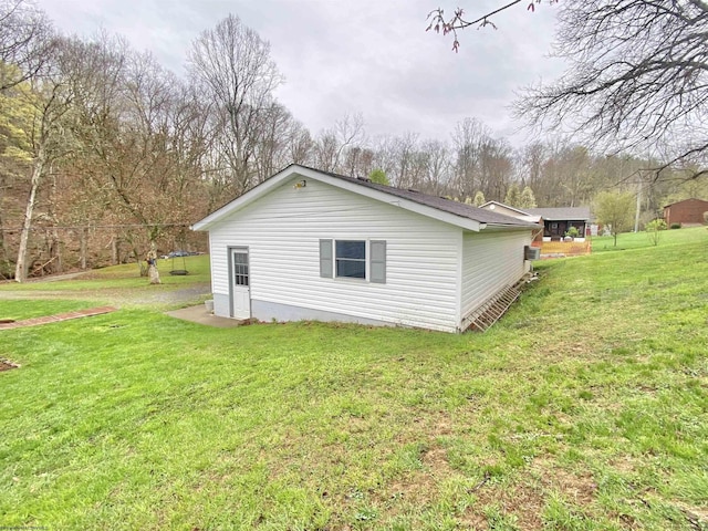 view of side of home featuring a yard