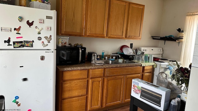 kitchen featuring white appliances, a sink, brown cabinetry, and open shelves