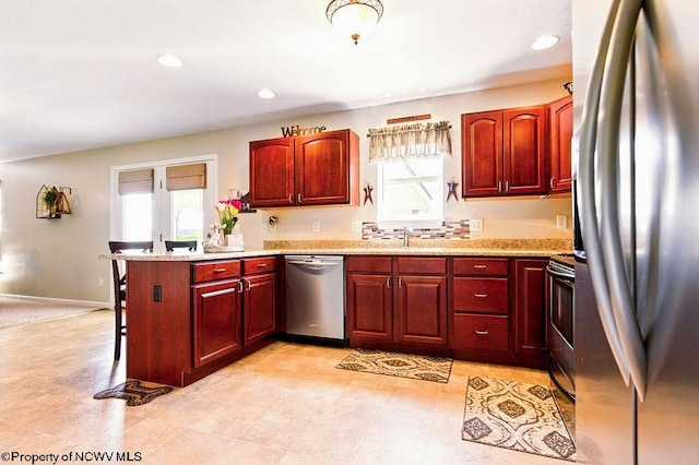 648 Ashberry Dr, Flemington, WV 26347 - kitchen featuring a peninsula, dark brown cabinets, recessed lighting, stainless steel appliances, and a breakfast bar area