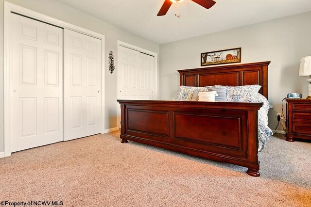 648 Ashberry Dr, Flemington, WV 26347 - bedroom featuring two closets, baseboards, a ceiling fan, and light colored carpet