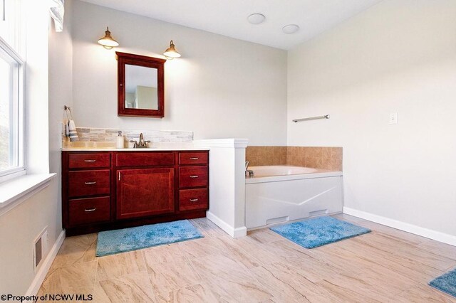 648 Ashberry Dr, Flemington, WV 26347 - full bath with visible vents, baseboards, vanity, and a garden tub