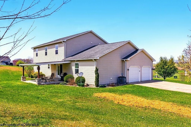648 Ashberry Dr, Flemington, WV 26347 - view of front of home featuring concrete driveway, cooling unit, a front lawn, an attached garage, and a patio area