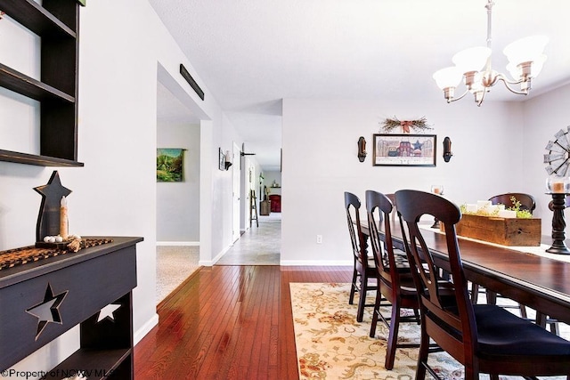 648 Ashberry Dr, Flemington, WV 26347 - dining room with a notable chandelier, hardwood / wood-style flooring, and baseboards