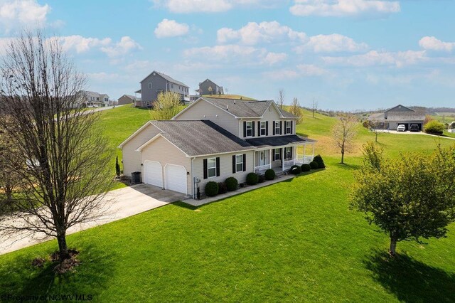 648 Ashberry Dr, Flemington, WV 26347 - traditional-style home featuring a front yard, an attached garage, and covered porch