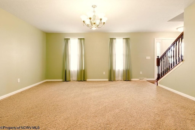 648 Ashberry Dr, Flemington, WV 26347 - carpeted empty room with a chandelier, stairs, and baseboards