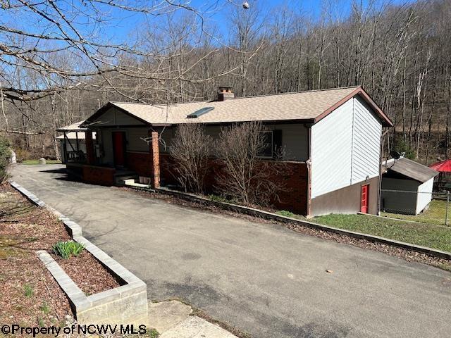 140 Roney Rd, Elkins, WV 26241 - view of front of property with a wooded view and a chimney
