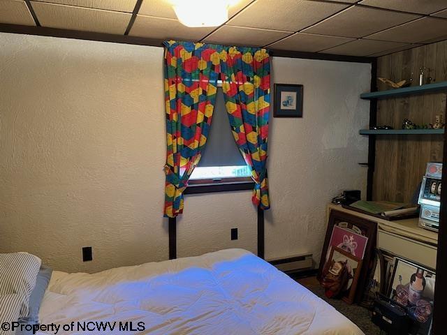 140 Roney Rd, Elkins, WV 26241 - bedroom featuring a textured wall, baseboard heating, and a drop ceiling