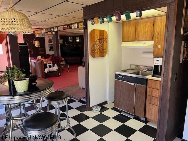 140 Roney Rd, Elkins, WV 26241 - kitchen featuring brown cabinets, range hood, light countertops, and light floors