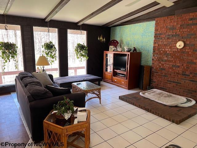140 Roney Rd, Elkins, WV 26241 - living area featuring brick wall, light tile patterned floors, and vaulted ceiling with beams