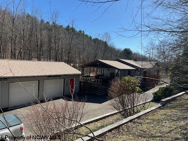 140 Roney Rd, Elkins, WV 26241 - view of front facade featuring an outbuilding, a garage, and roof with shingles
