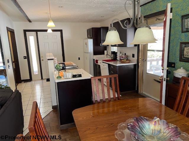 140 Roney Rd, Elkins, WV 26241 - kitchen featuring a center island, white appliances, light countertops, and hanging light fixtures