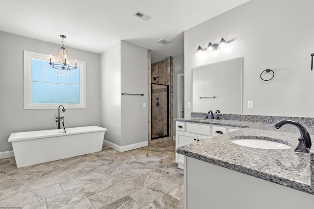 full bathroom with visible vents, a freestanding bath, a notable chandelier, vanity, and a stall shower