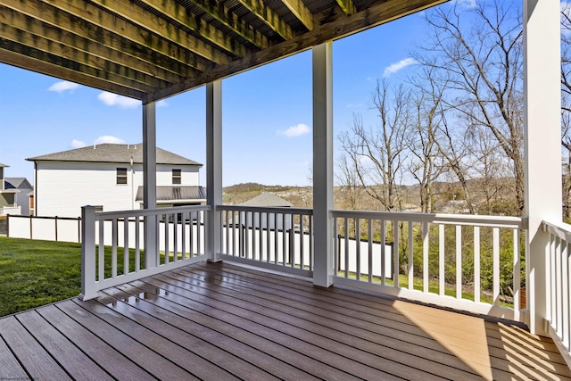 wooden terrace featuring a yard