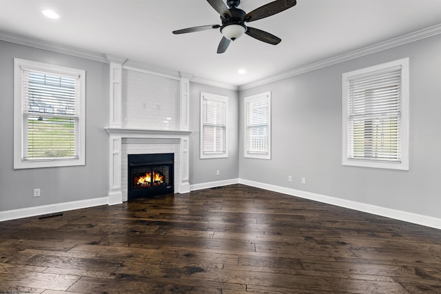 unfurnished living room featuring ornamental molding, a fireplace, dark wood finished floors, and baseboards