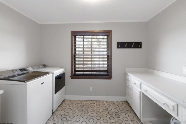 laundry room featuring separate washer and dryer, baseboards, ornamental molding, and cabinet space