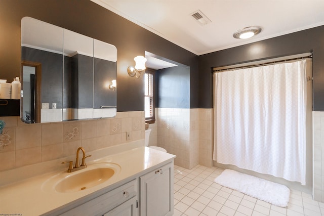full bathroom with tile patterned floors, visible vents, vanity, a shower with curtain, and tile walls