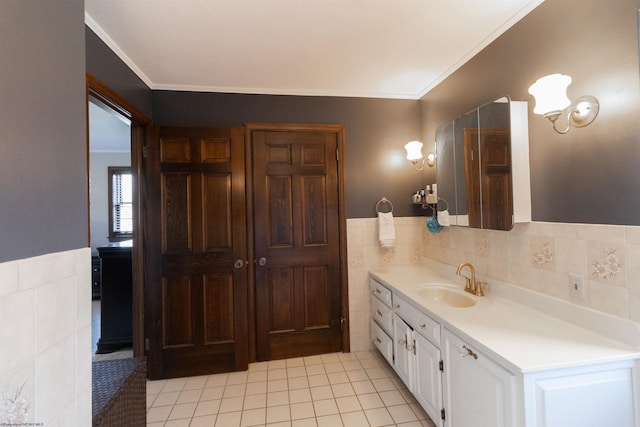 bathroom with crown molding, vanity, tile patterned floors, and tile walls