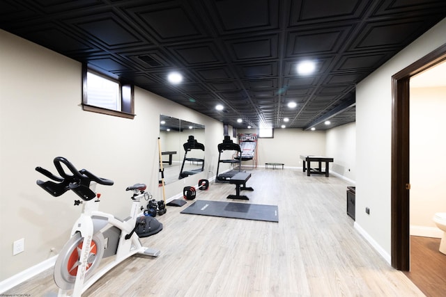 workout room featuring wood finished floors and baseboards