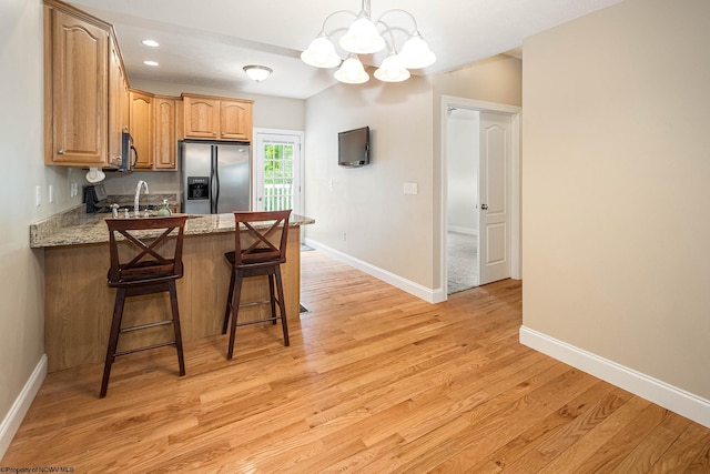 306 Villa View Dr, Morgantown, WV 26505 - kitchen featuring stainless steel appliances, baseboards, a peninsula, light wood-style flooring, and a notable chandelier