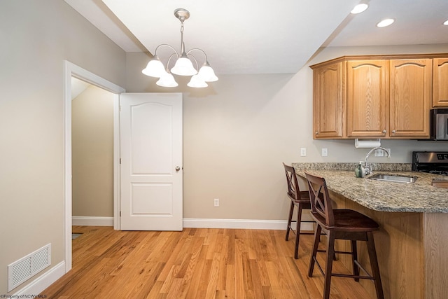 306 Villa View Dr, Morgantown, WV 26505 - kitchen featuring stone counters, visible vents, a sink, and light wood-style flooring