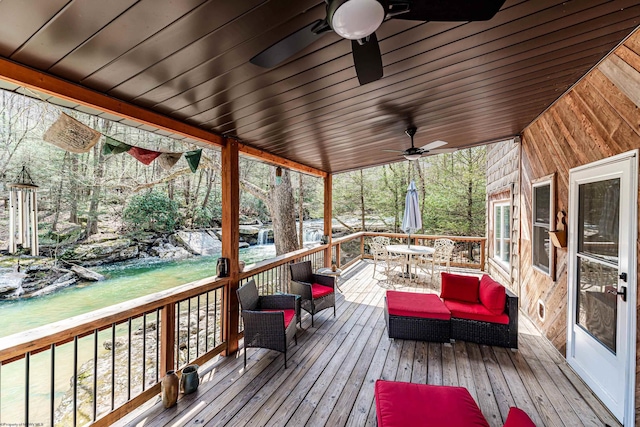 wooden deck featuring outdoor dining space and ceiling fan
