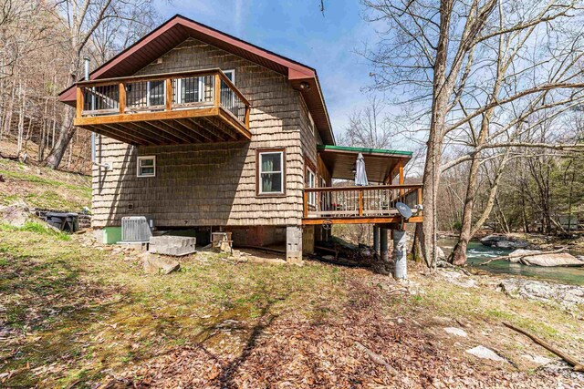 view of side of home featuring central AC and a wooden deck
