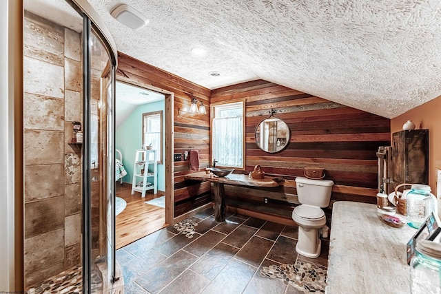 sitting room with lofted ceiling, a textured ceiling, and wooden walls