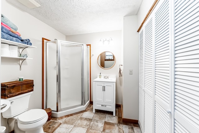 full bath with toilet, vanity, a closet, and a stall shower