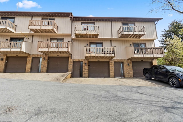 1224 Van Voorhis Rd, Morgantown, WV 26505 - view of front facade with driveway, brick siding, and a garage
